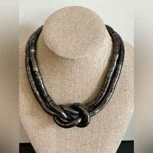 EXPRESS bendable gunmetal gray link rope chain tied in knot sits at collar bone